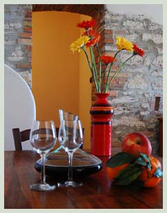 Downstairs dining table with flowers and homemade wine